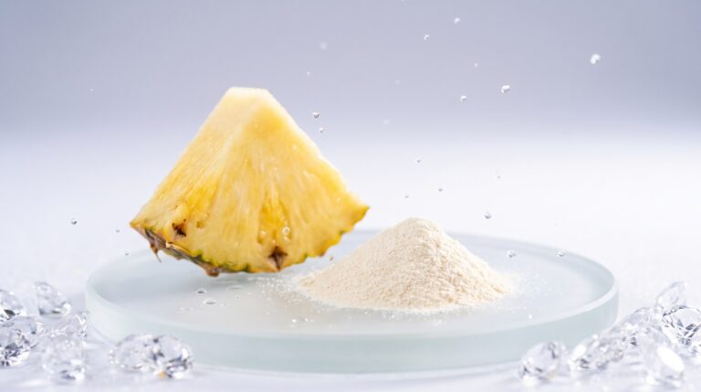 A wedge of fresh pineapple beside a small heap of pale standardised extract powder on a glass disc, the difference between the fruit and the extract a supplement actually contains