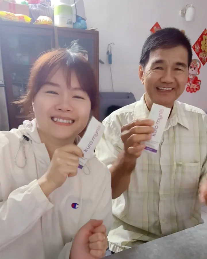 Kura Mynis customer holding a sachet