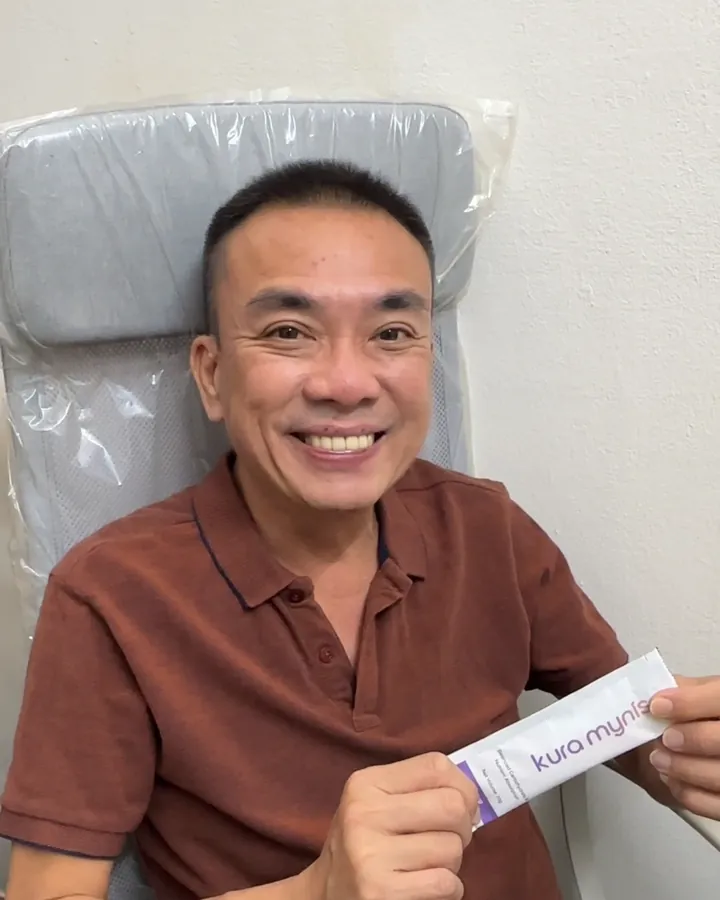 Kura Mynis customer holding a sachet
